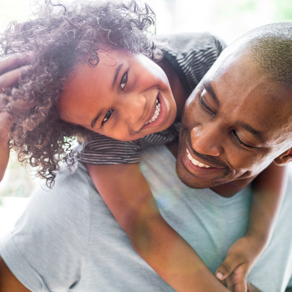 Father and son smiling after the dental treatment in Trenton, MI