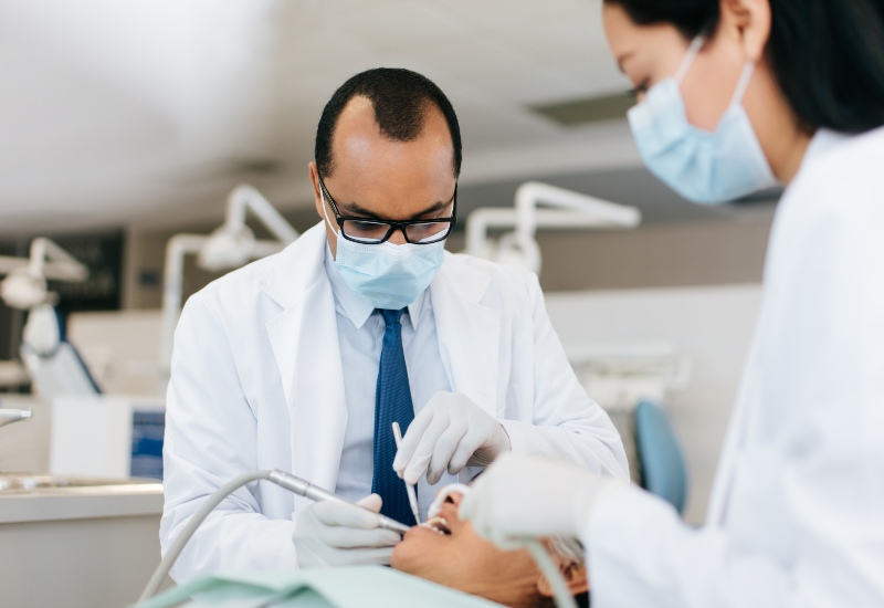 Dentist performing treatment for broken tooth in Trenton, MI