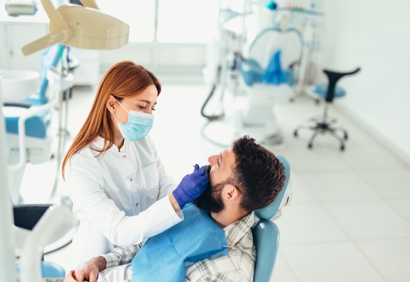 Dentist performing dental crown treatment in Trenton, MI