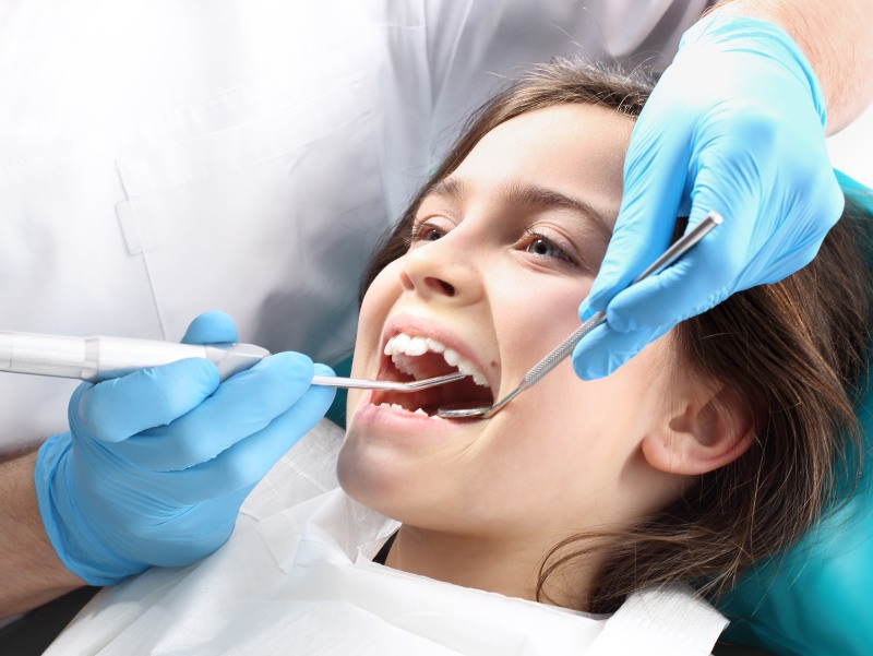 Child receiving fluoride dental care in Trenton, MI