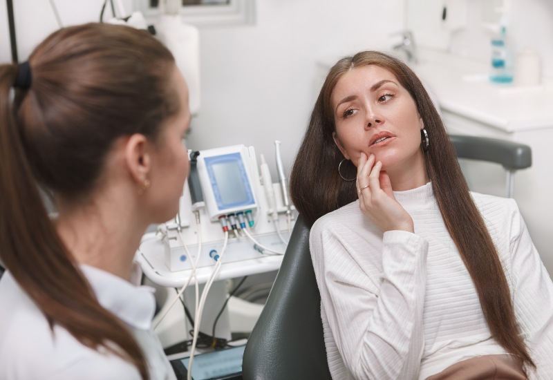 Dental professional in Trenton, MI guiding patient on tooth sensitivity care.